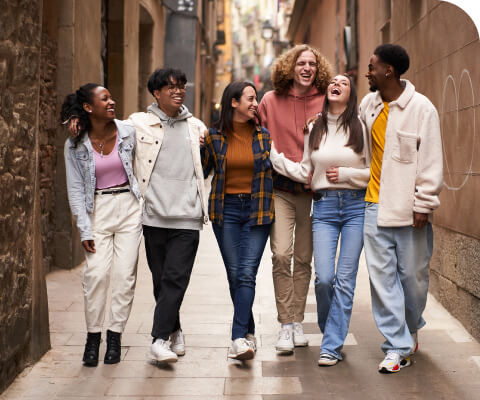 A group of friends walking down an alley.