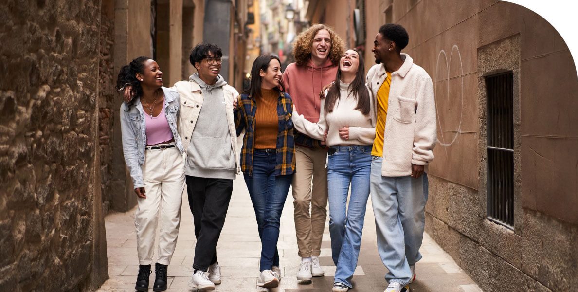 A group of friends walking down an alley.