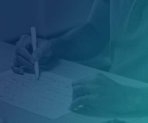 A person is writing on a piece of paper.