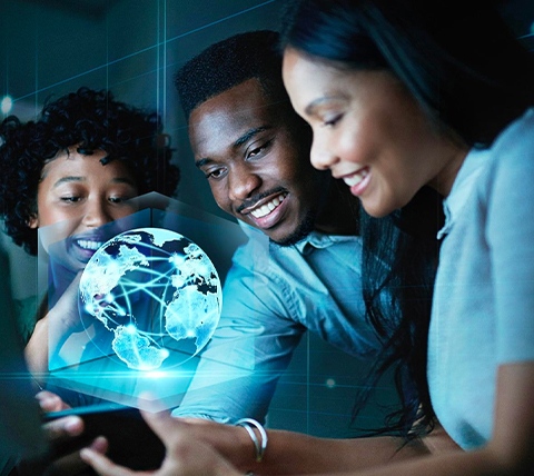 A group of people looking at a computer screen with a globe on it.